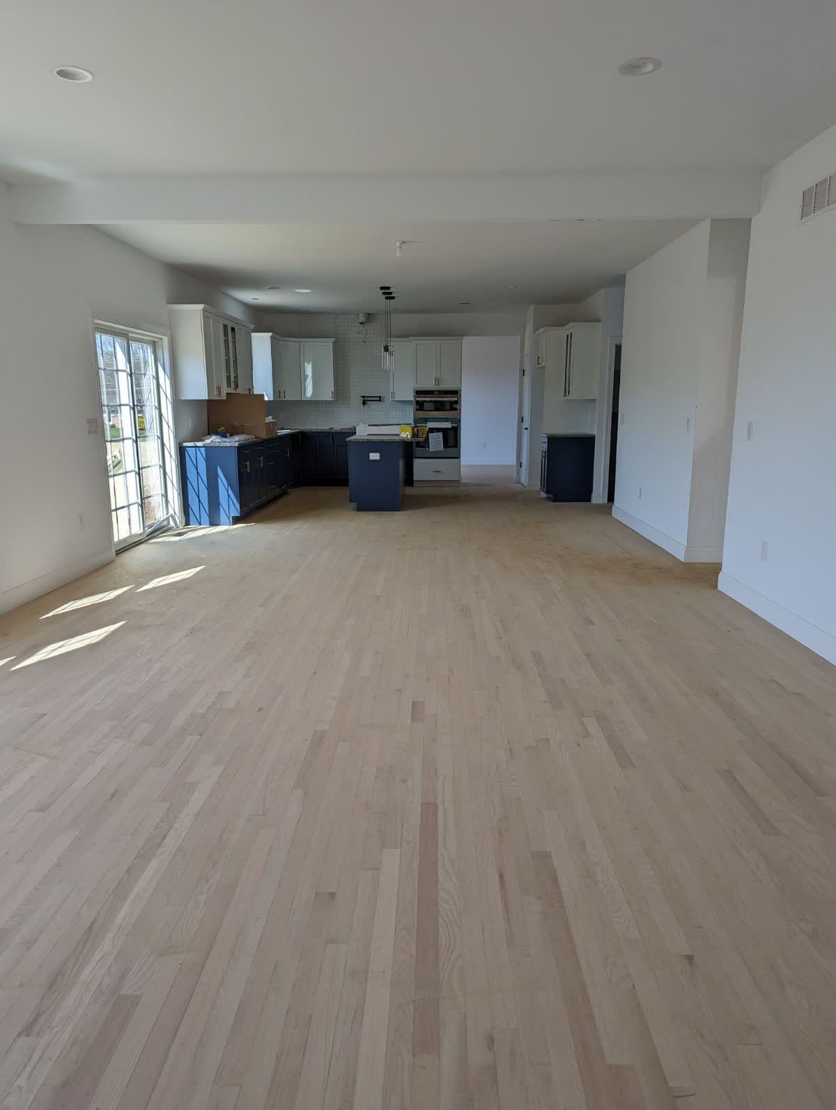 Wide-plank white oak flooring in a great room, one of our installed projects